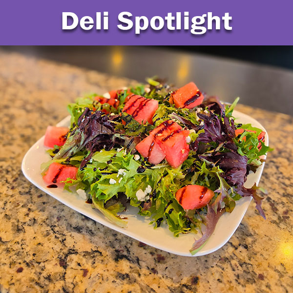 Watermelon Goat Cheese Salad with mixed greens and balsamic vinaigrette on a white plate